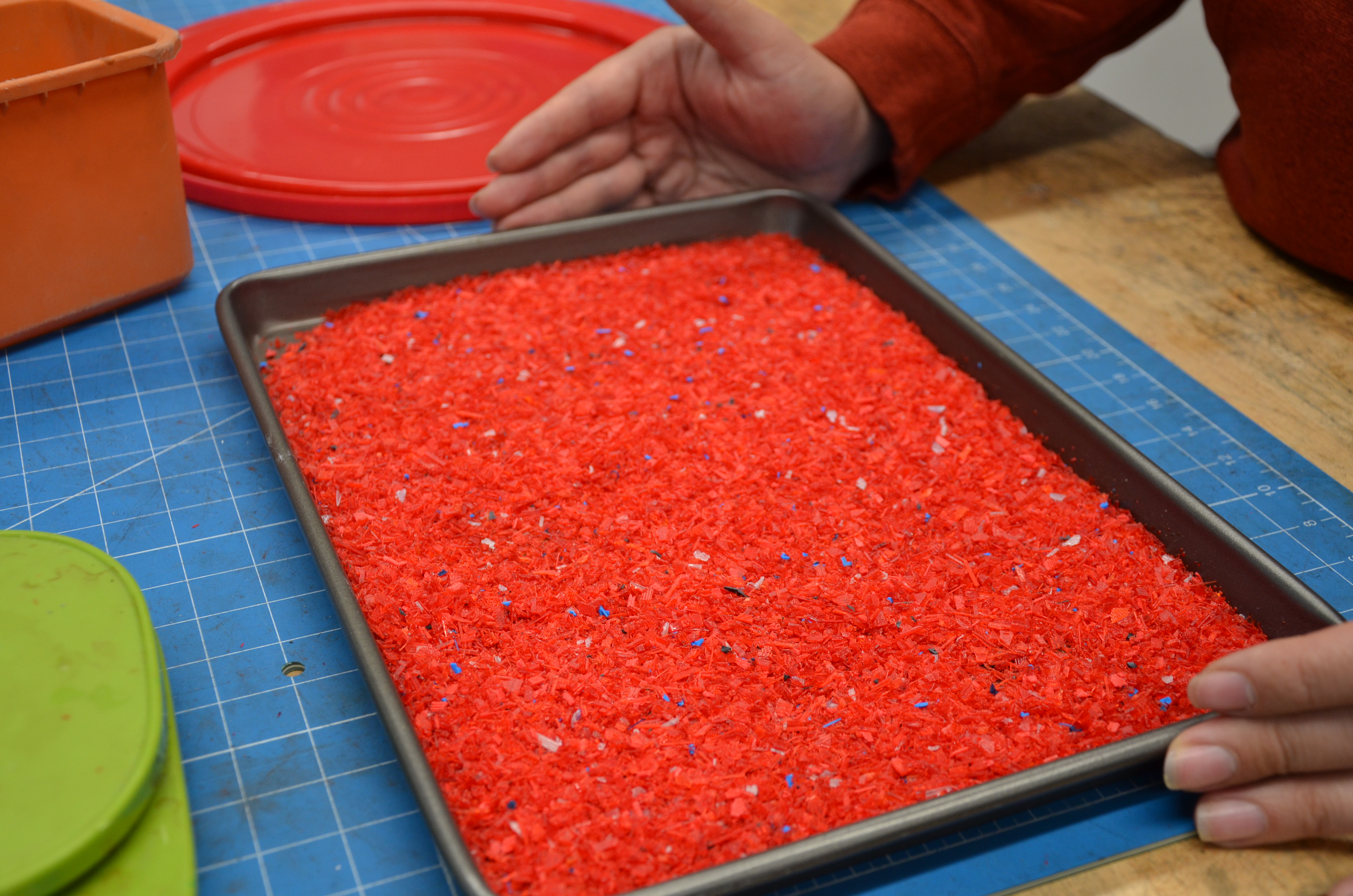 baking tray with tiny pieces of red plastics