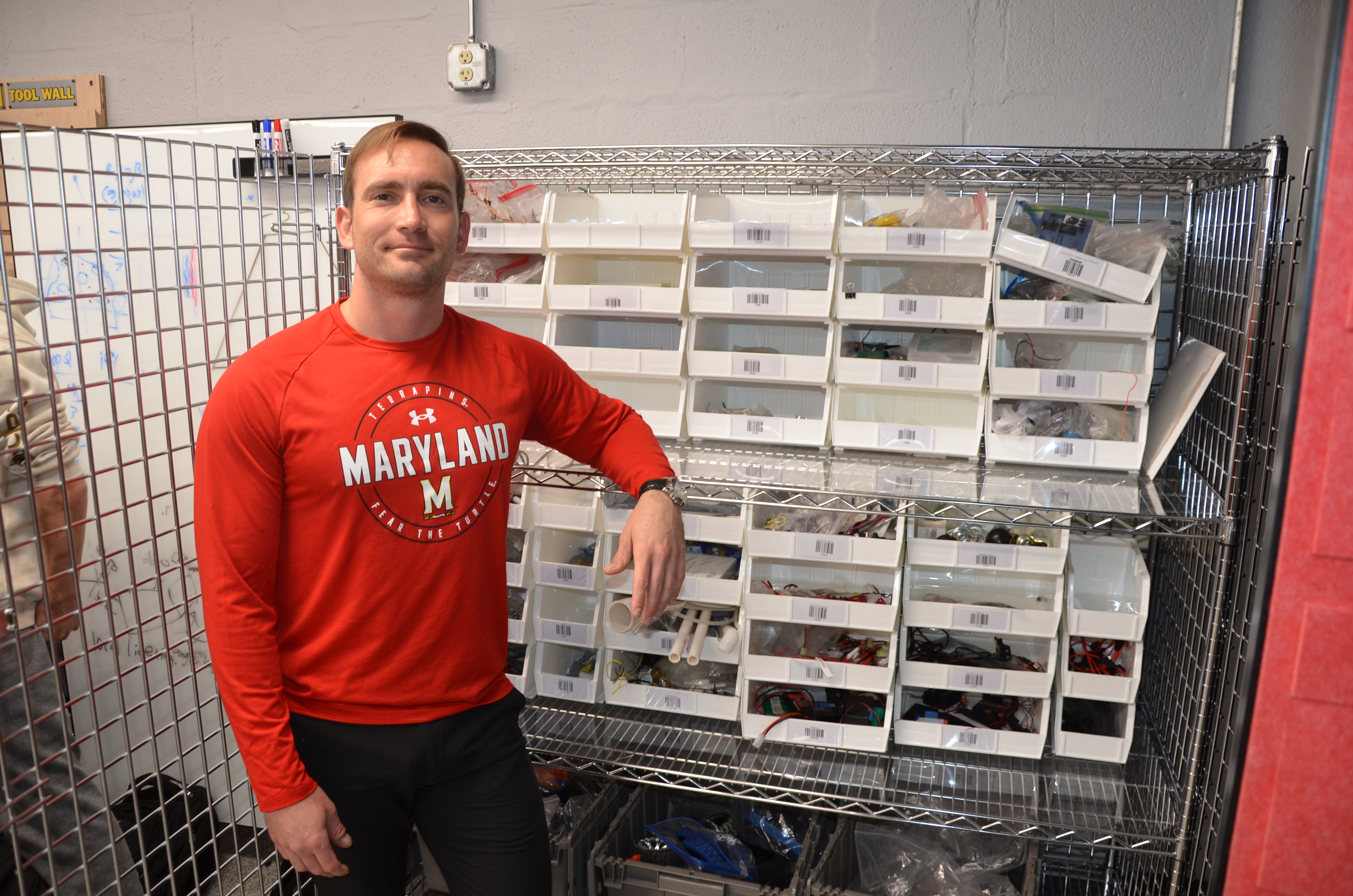 ENES100 Instructor and school store manager, Michael Galczynski, stands in front of the "store's" organizers.