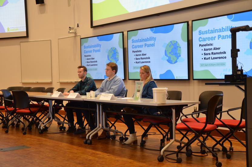 Three panelists sitting at table