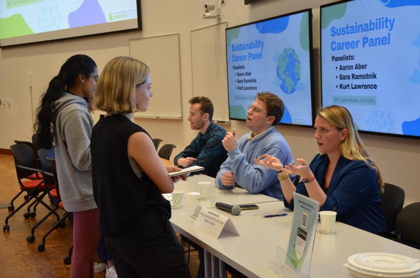 Students networking with the panelists