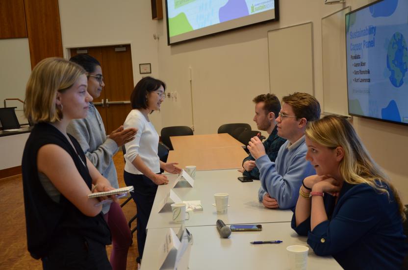 Students networking with the panelists