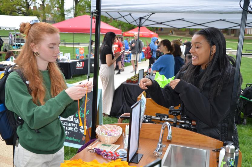 OS intern helping a student with the activity 