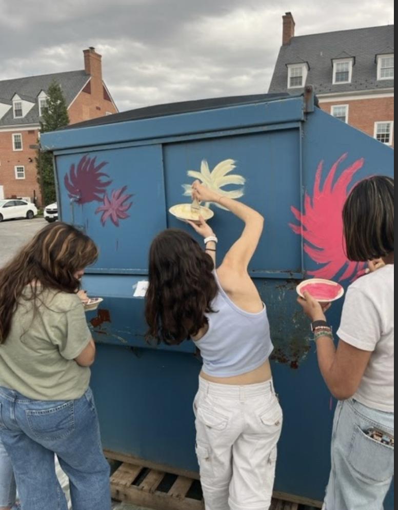 Students paint Lorax scene on dumpster.