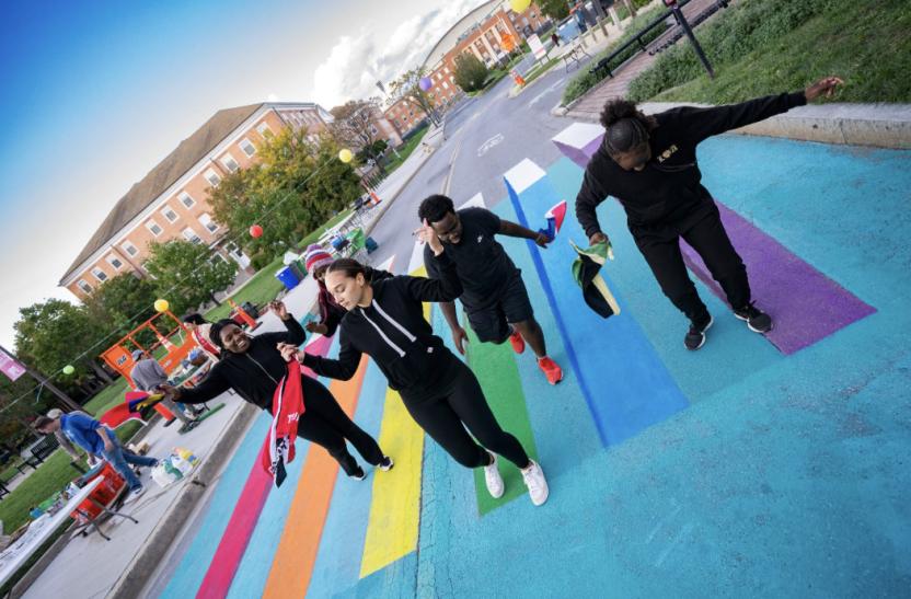 Volunteers standing on a decorating crosswalk