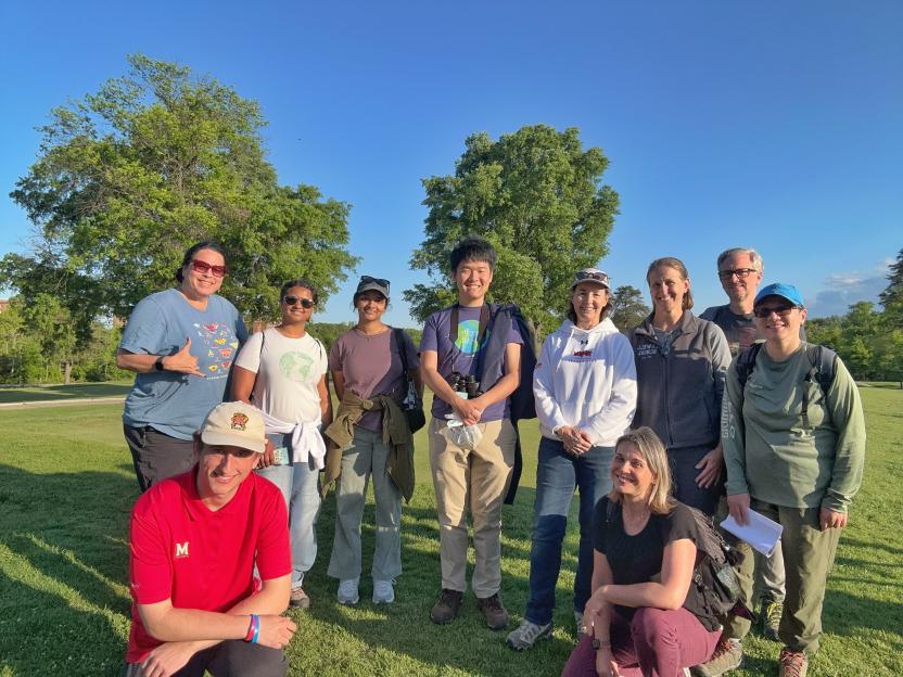 Group of people posing on the UMD Golf Course at BioBlitz, some wearing UMD gear