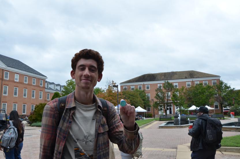 Student holding up finished button