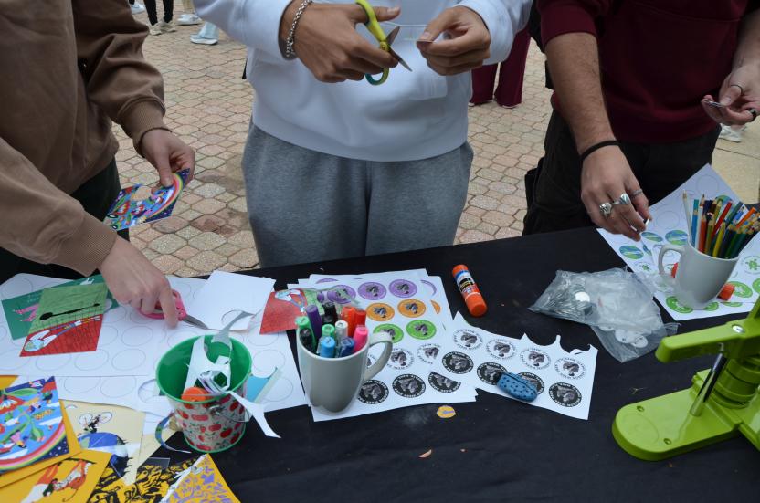 Students cutting out button prints
