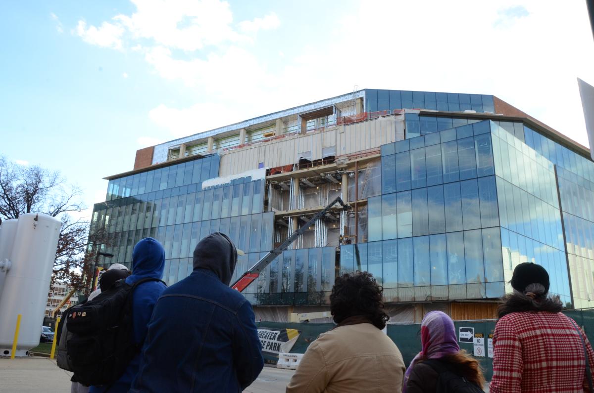 Tour groups stands in front of the Zupnik Hall Construction