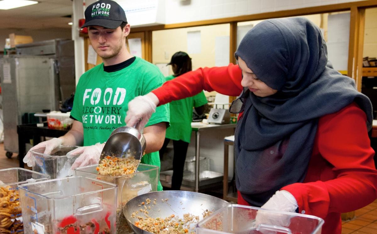 Undergraduate students transferring food for delivery to local organizations (pre COVID)