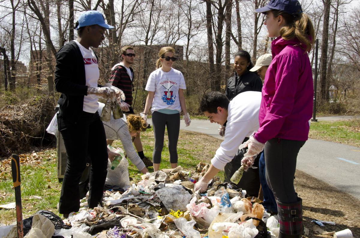 Students collecting trash and litter from campus creek