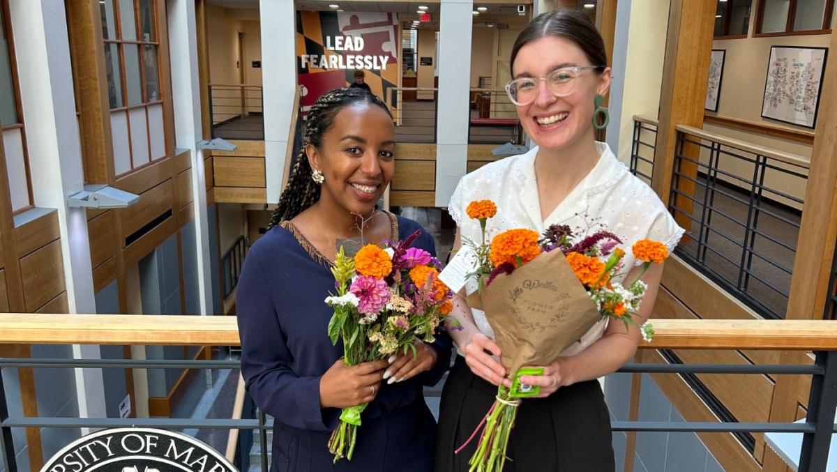 Staff pose with flower bouquets