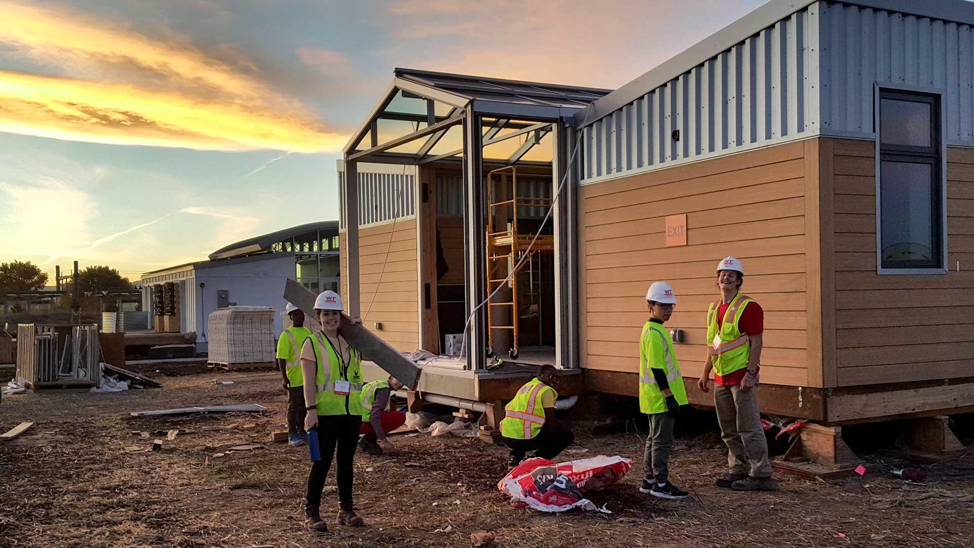  Maryland team members assemble the reACT house in Denver for the 2017 Solar Decathlon, in which UMD took second place overall, and fielded the top-ranked U.S. entry. Faculty, staff and at least one student who worked on reACT are part of a new Department of Energy-sponsored solar competition in 2021. (Photo by WP Andros)