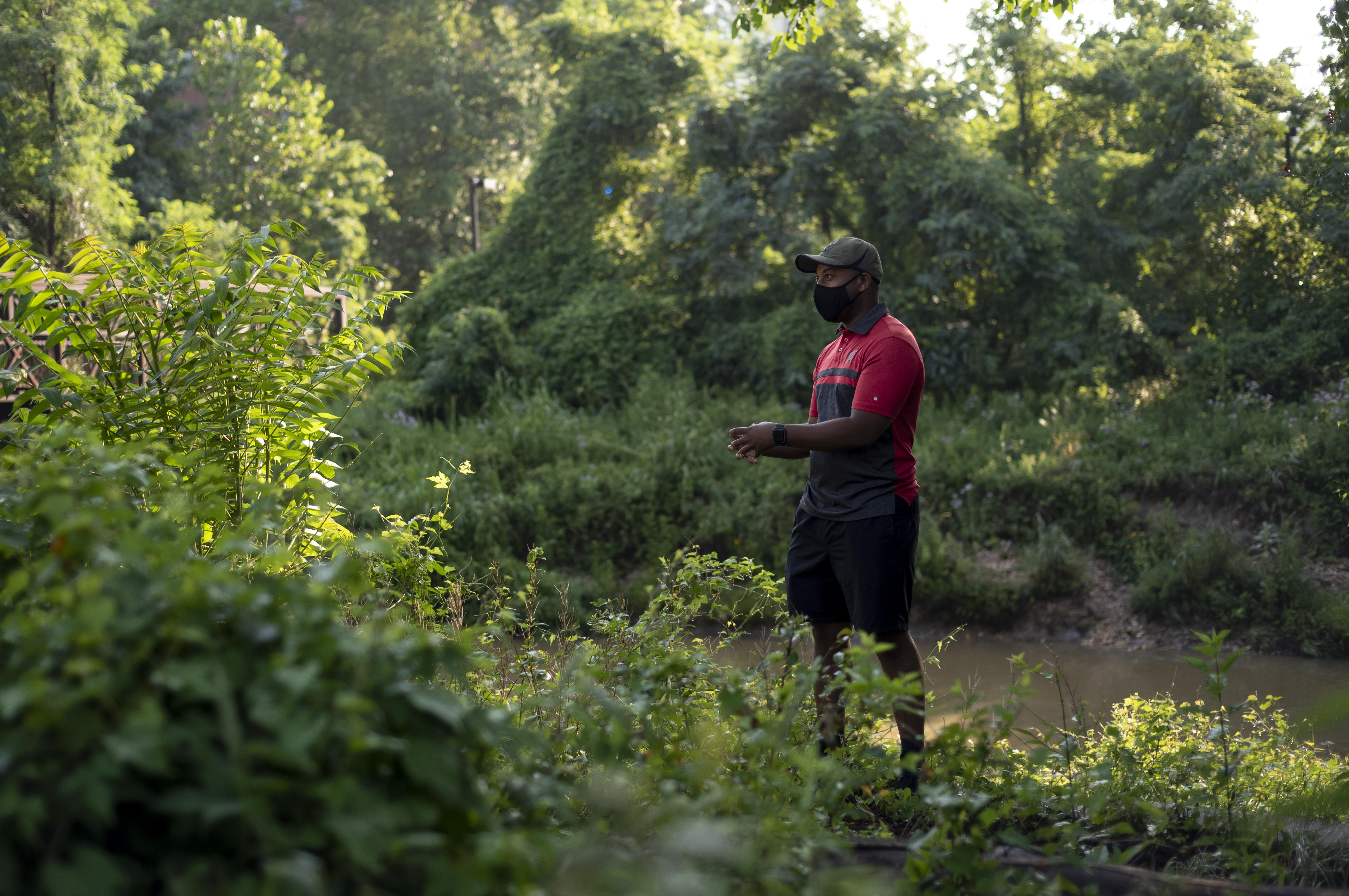 Man on bank on creek