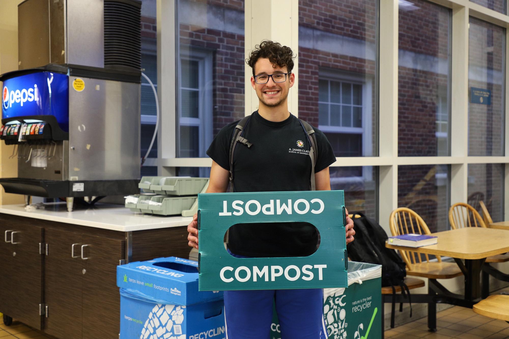 Student with Compost Collection Bin in Dining Hall