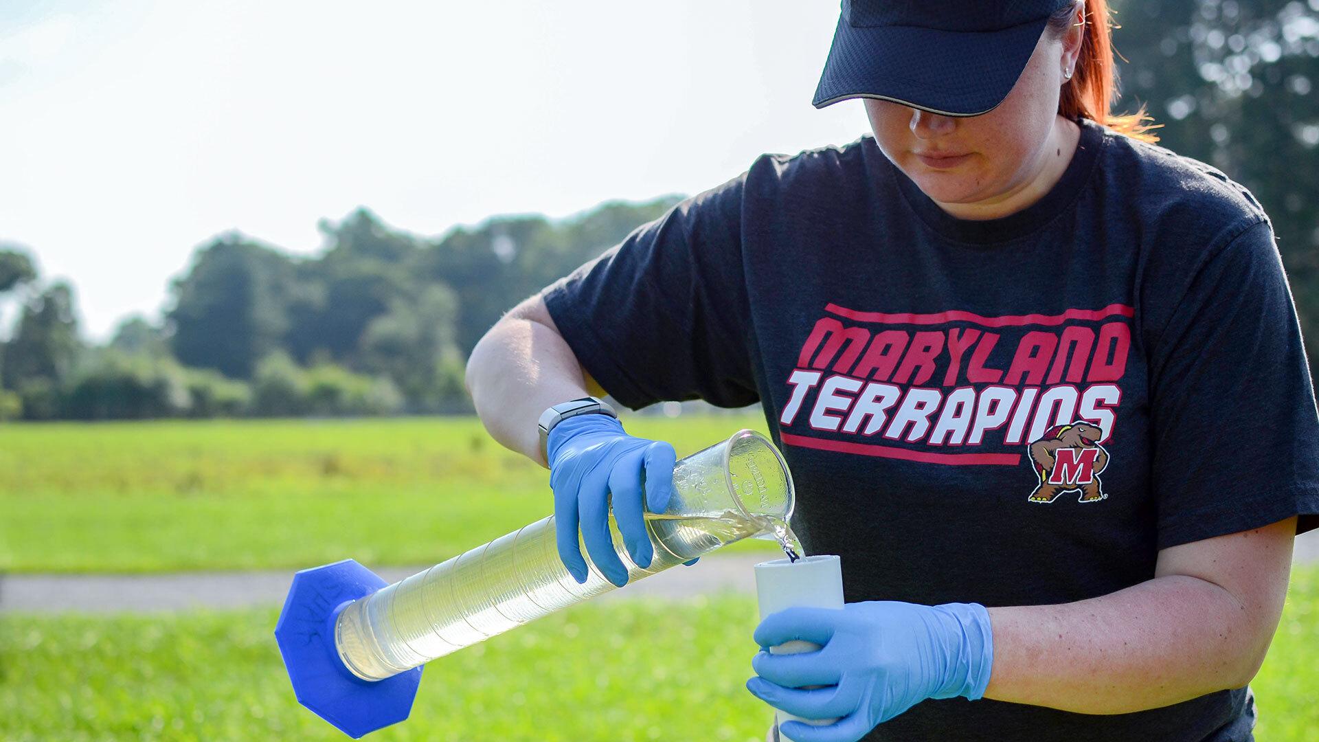Student measuring water chemistry (picture)