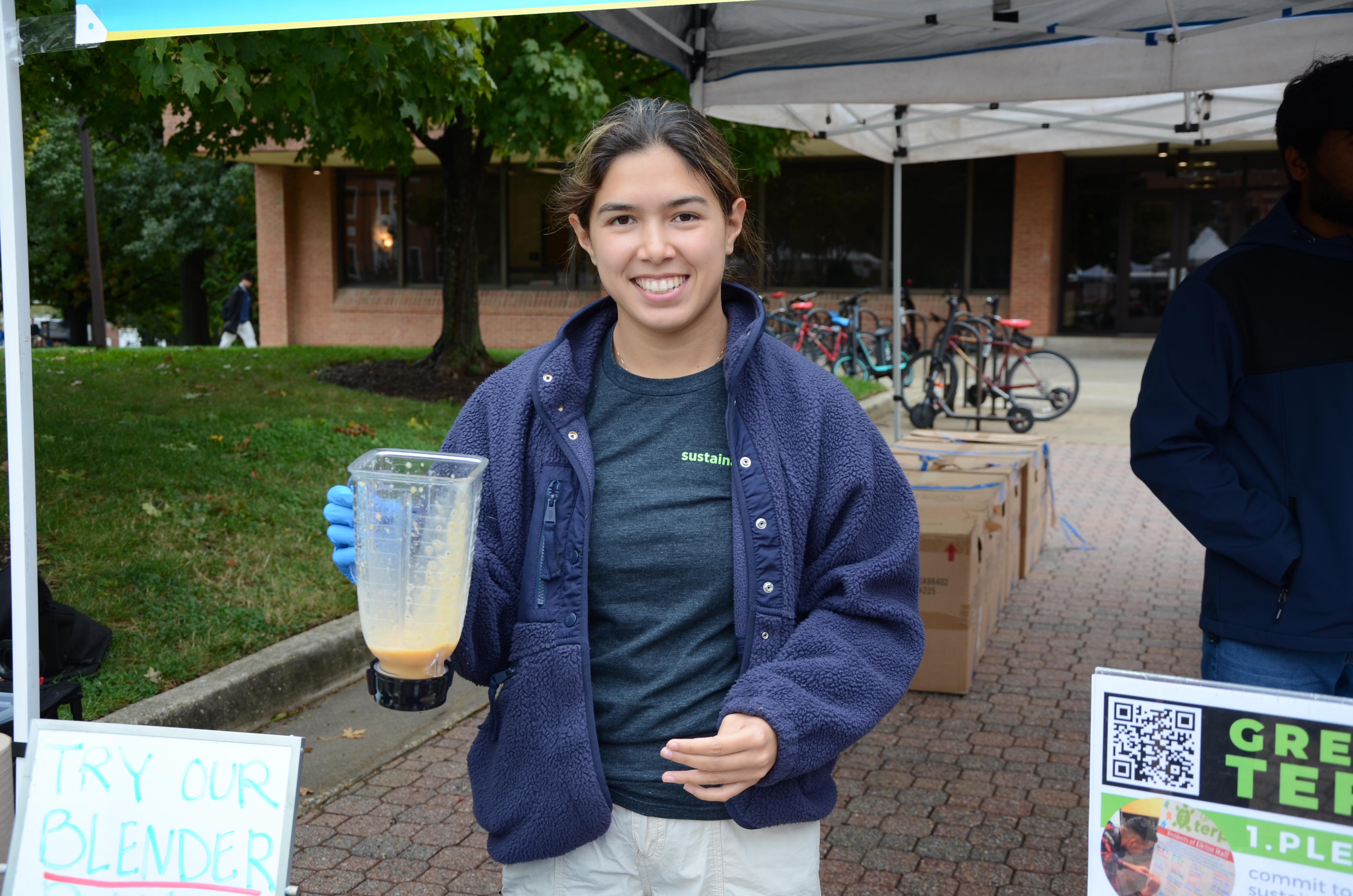 Student holds up blender 
