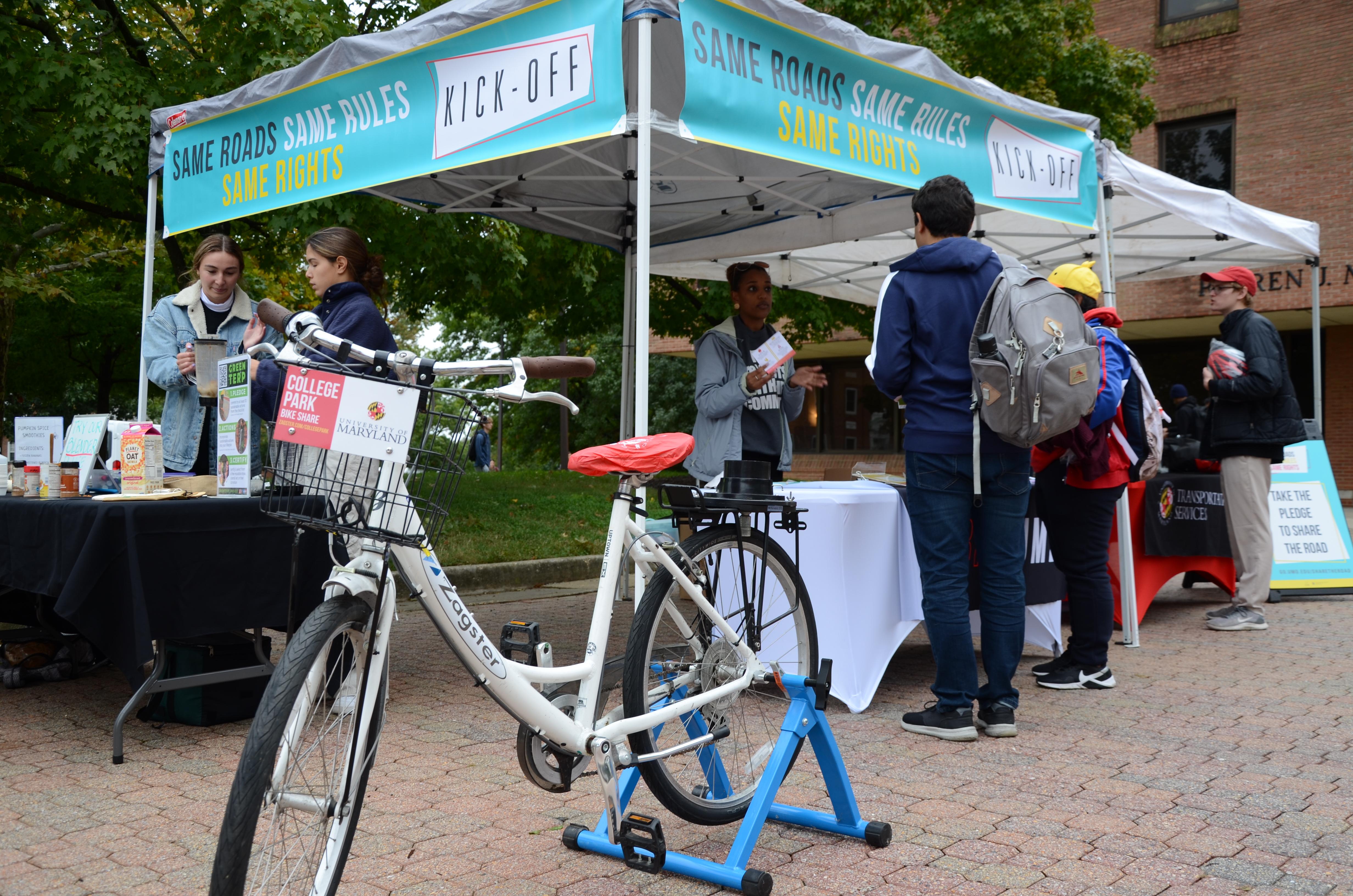 Photo of tent and smoothie bike at farmers market