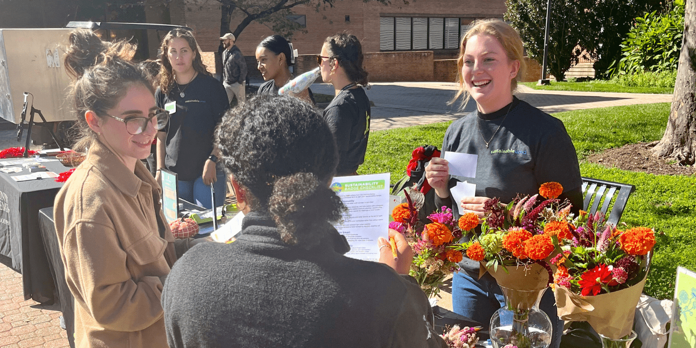 Student talks with Staff about Sustainability Badge