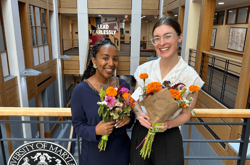 Staff pose with flower bouquets