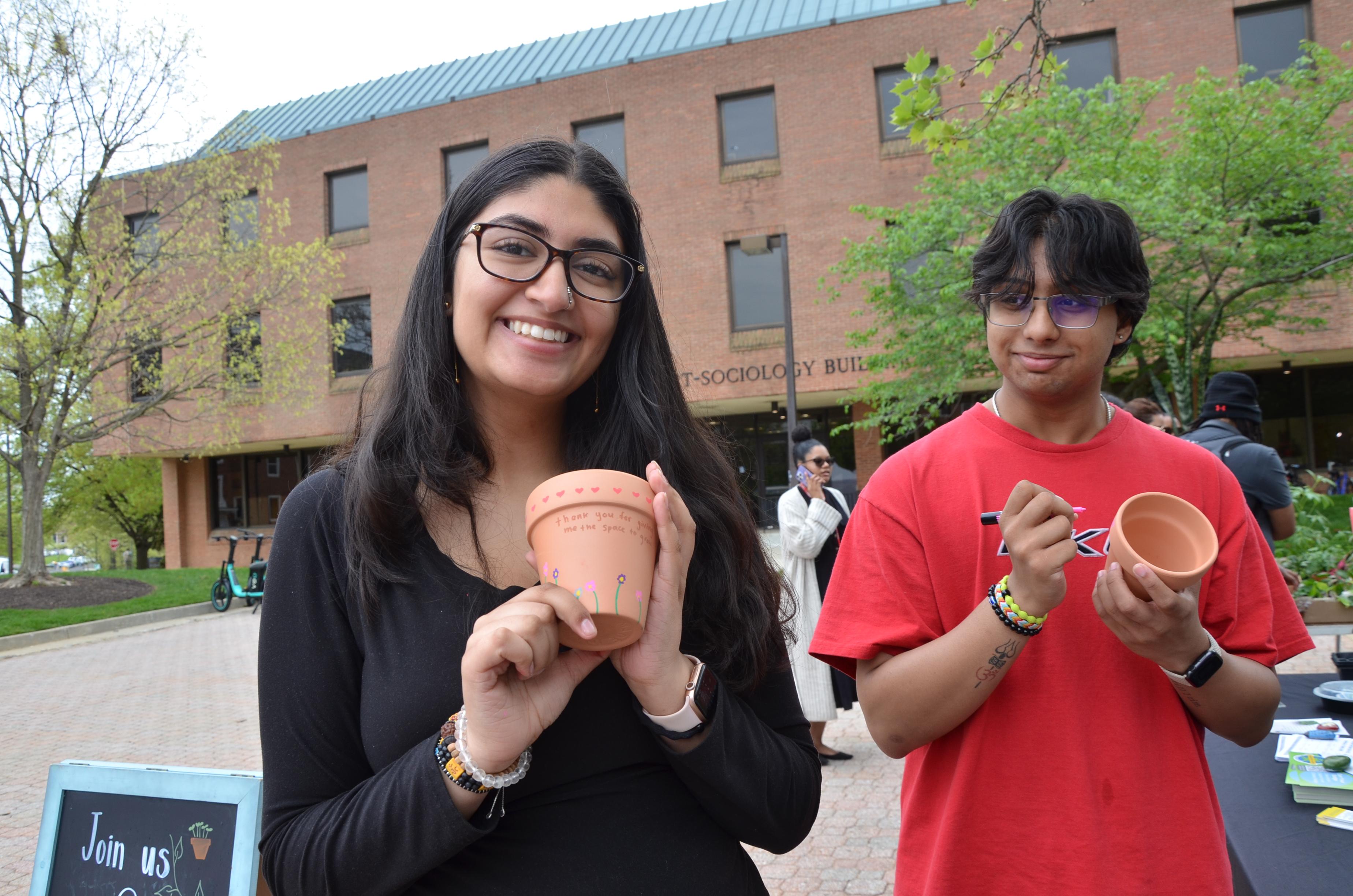 Student's posing with their pots