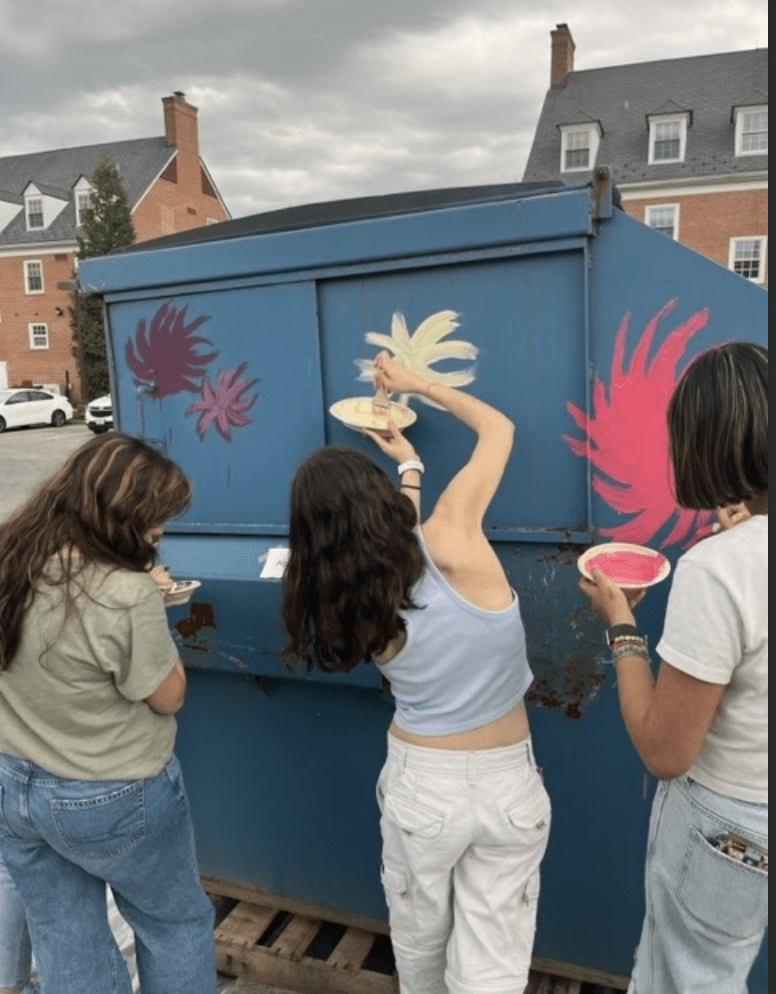 Students paint Lorax scene on dumpster.