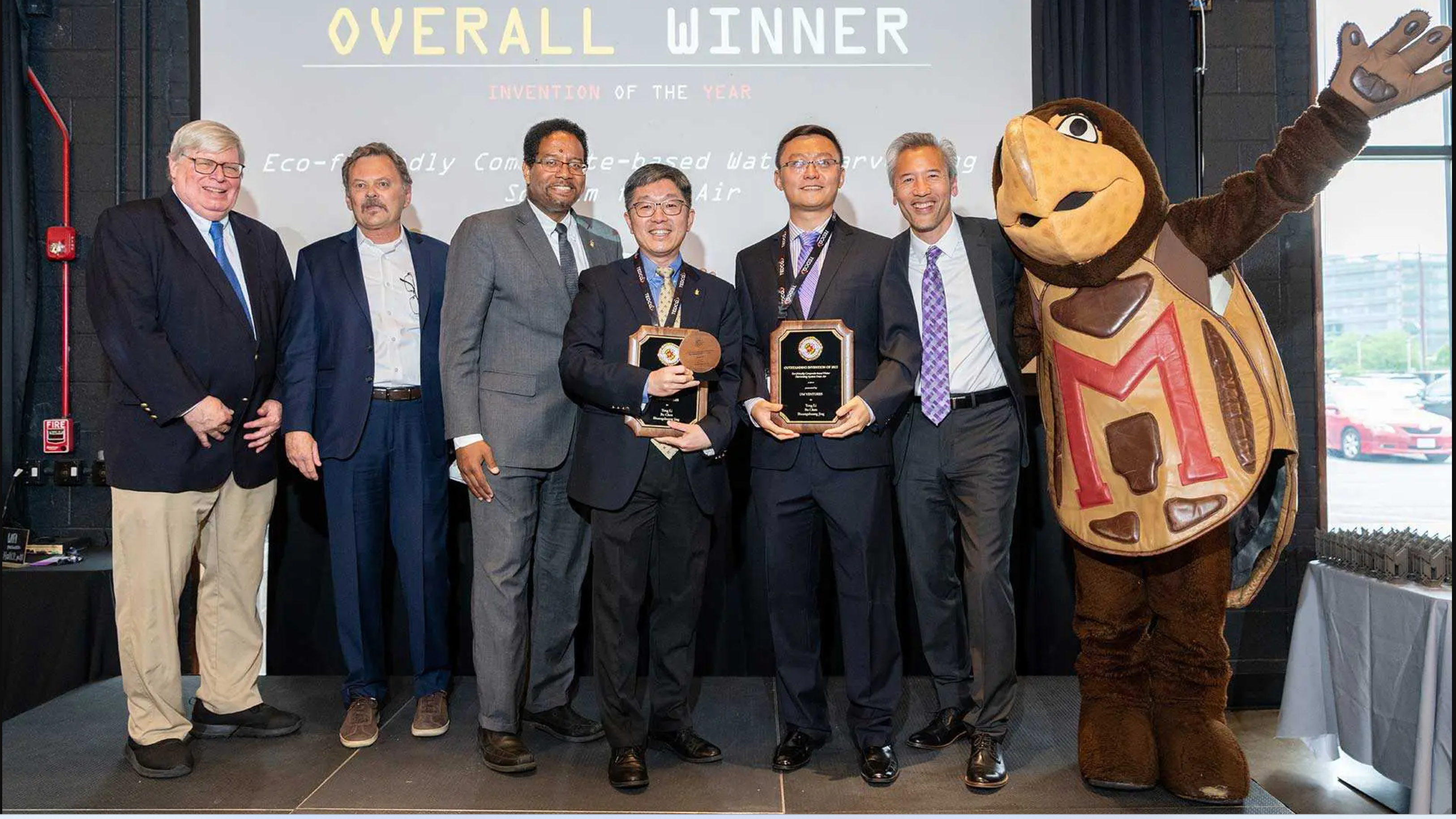 Invention of the Year winners hold awards on stage with Testudo and UMD leaders