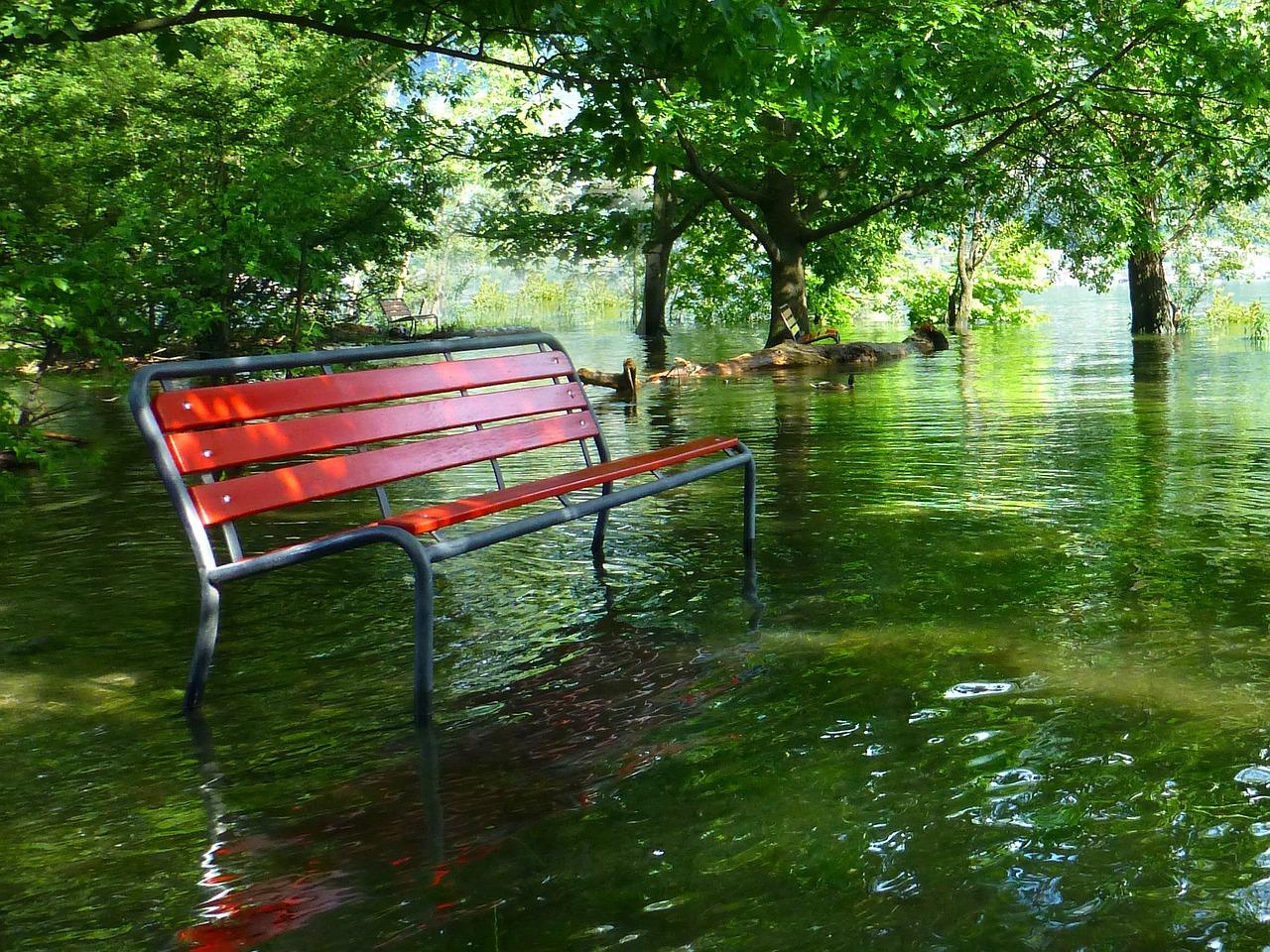 Red bench with flood waters rising around it