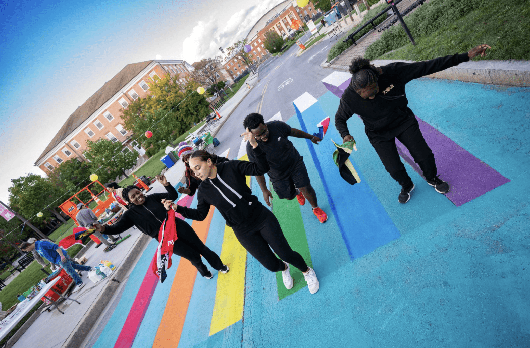 Volunteers standing on a decorating crosswalk