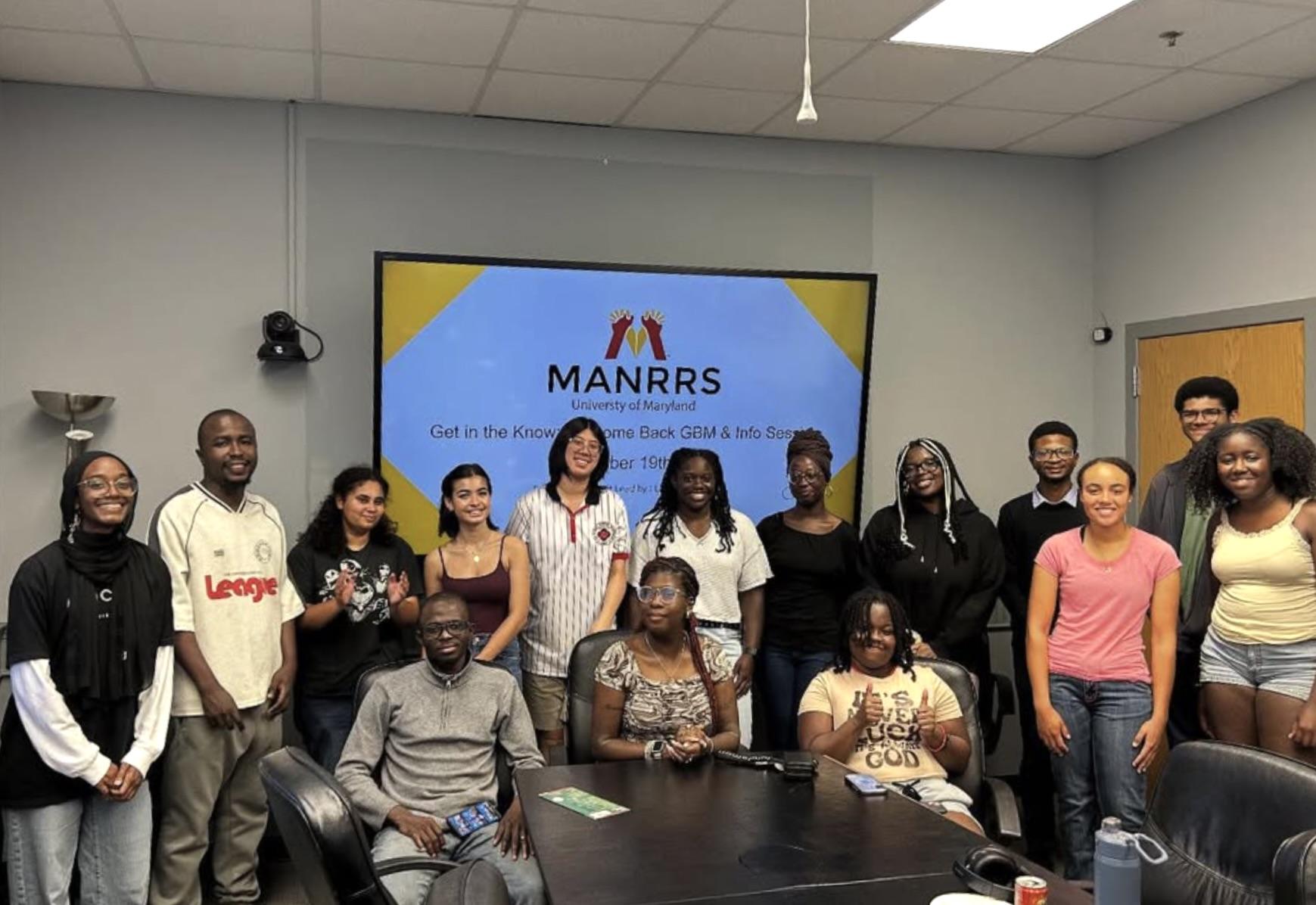 Students in MANRRS sit together in a conference room.