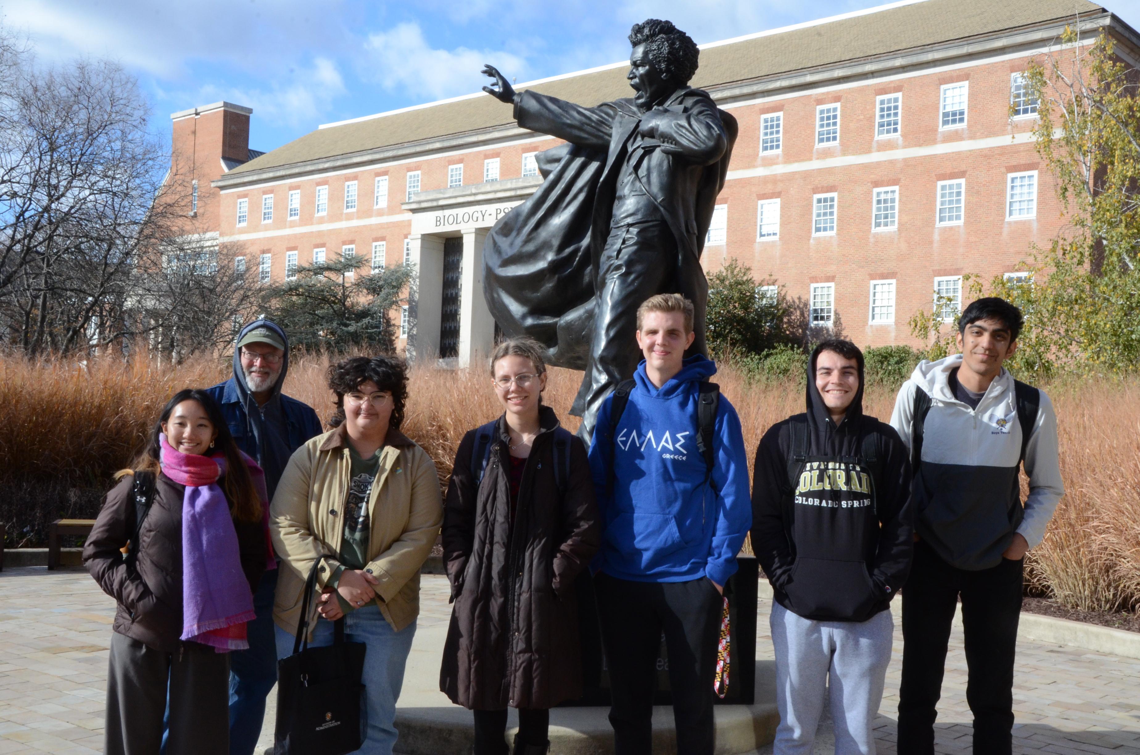 Tour groups standing in front of the Frederick Douglass Statue