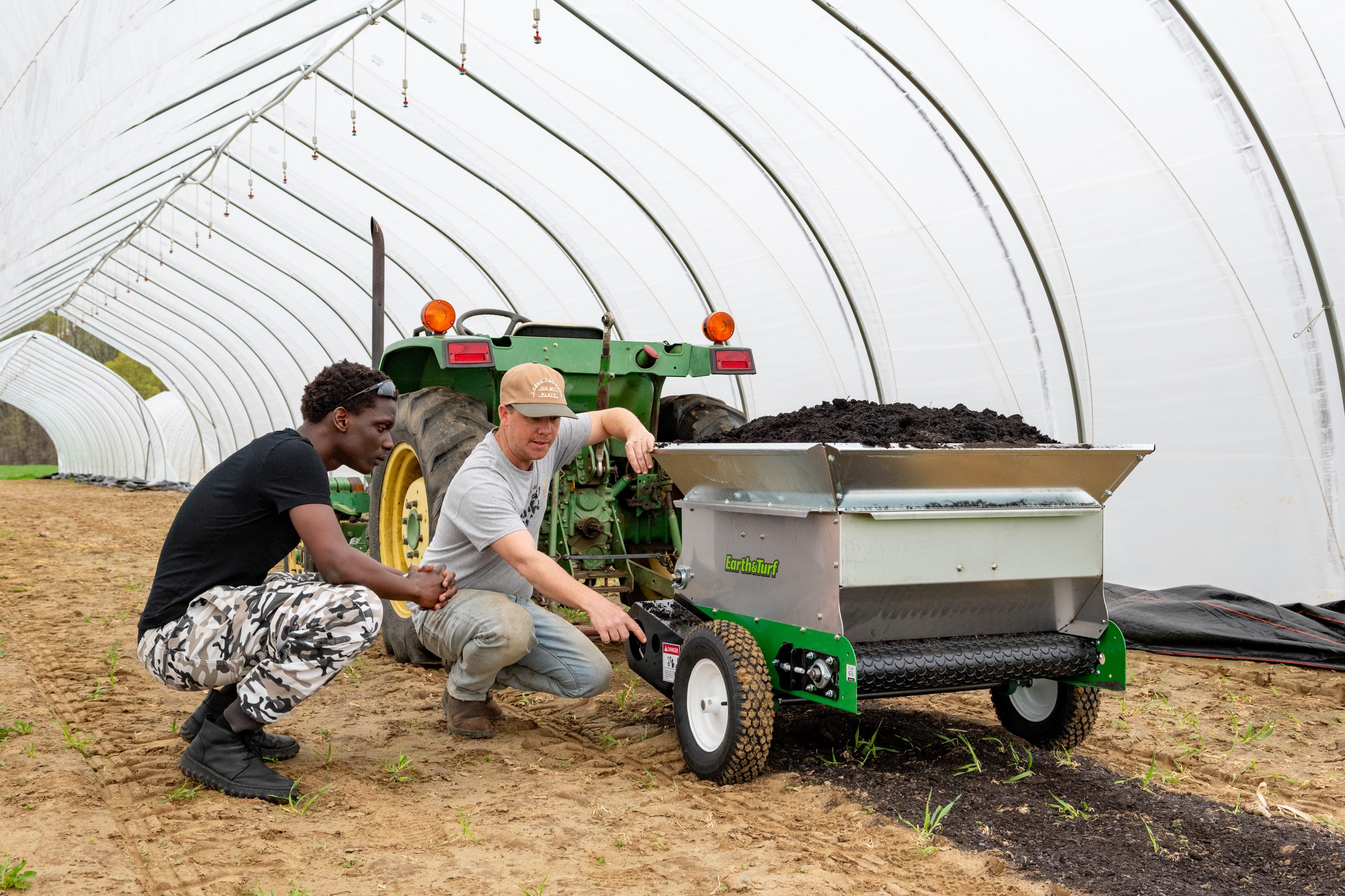Student and mentor with compost spreader at Terp Farm