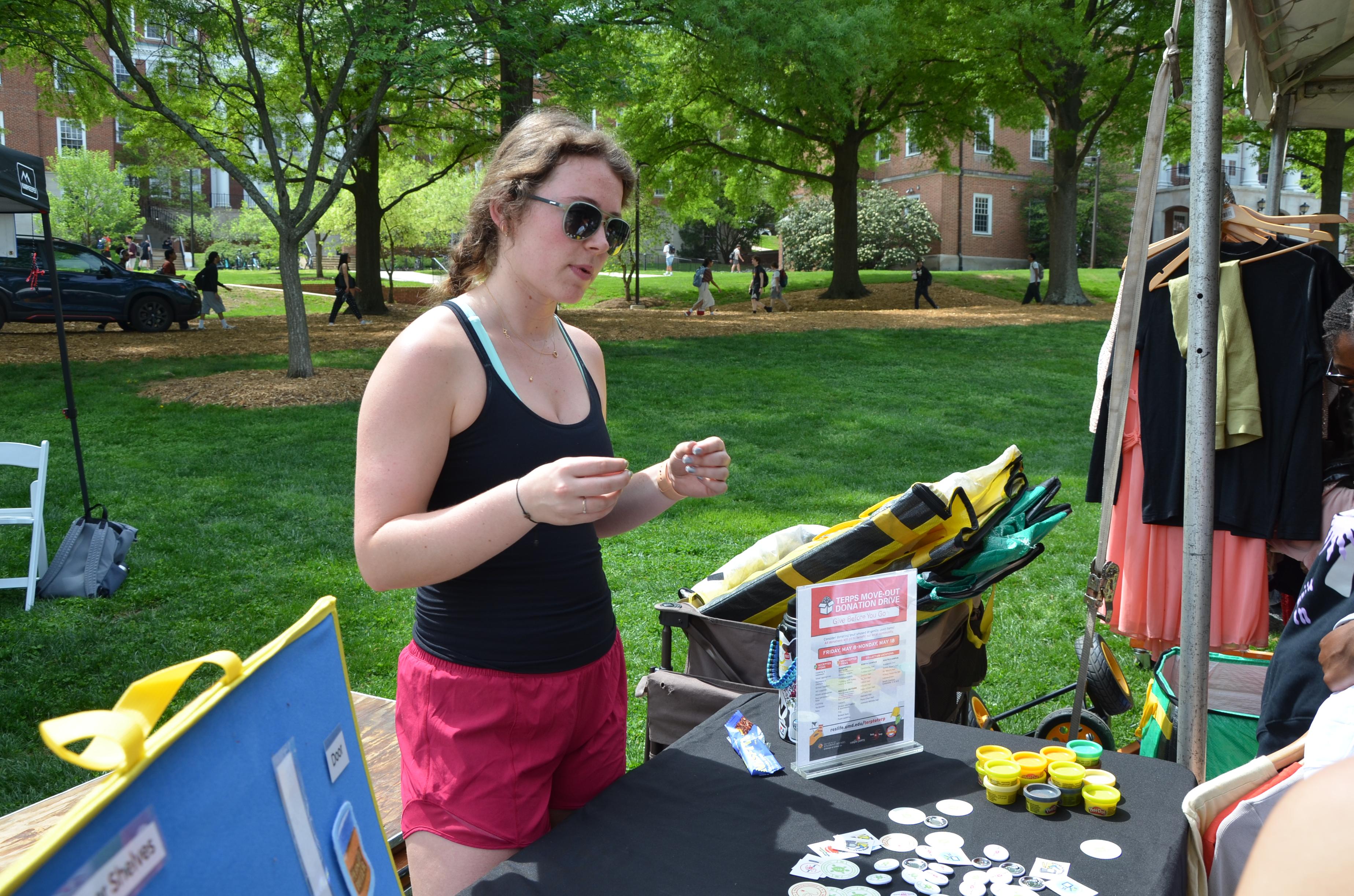 A student leads another student in a waste-sorting activity at EarthFest.