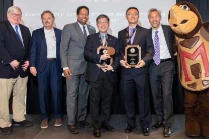 Group of University of Maryland researchers holding the Invention of the Year award with the Testudo mascot.