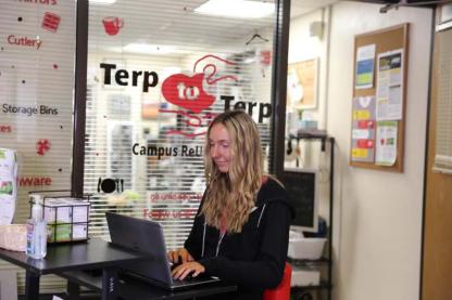 Staff member working at the Terp to Terp Campus ReUse Store counter on campus.